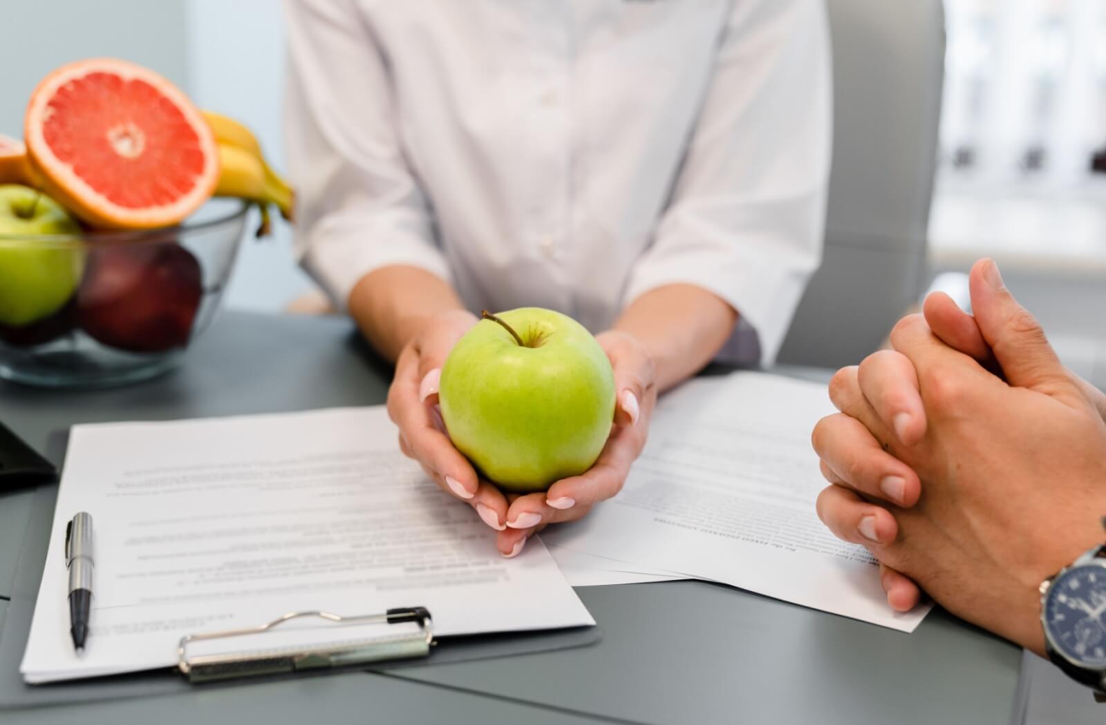 a professional holds an dapple in both hands